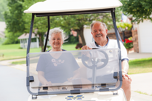 Senior couple in a golf cart