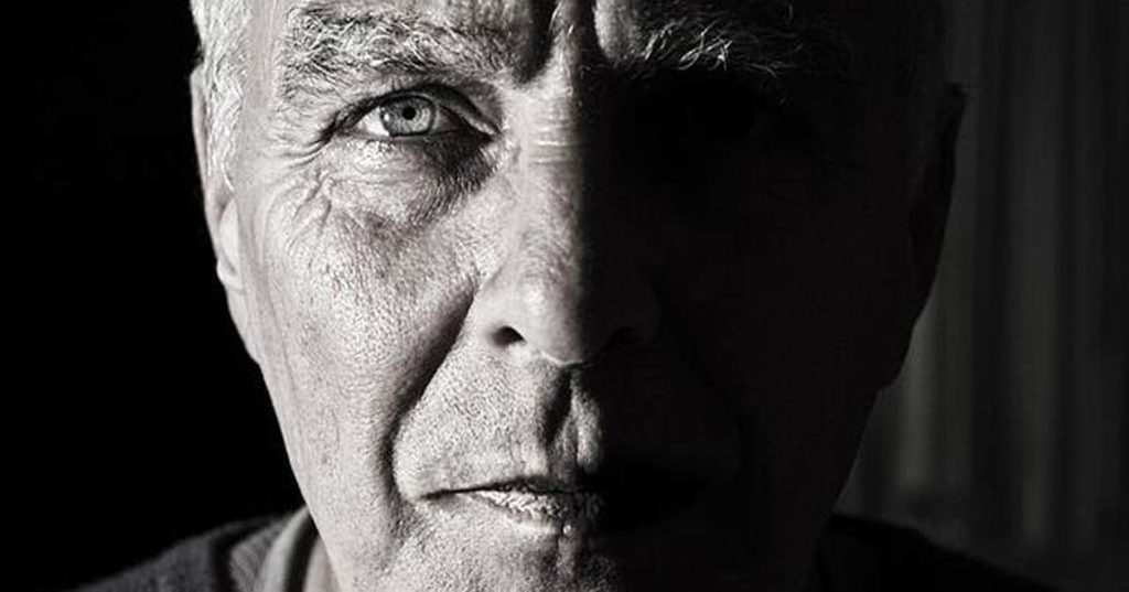 Black and white closeup photo of senior man