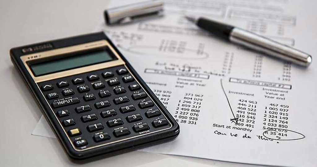 Calculator with financial papers