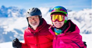 Senior man and woman enjoying skiing