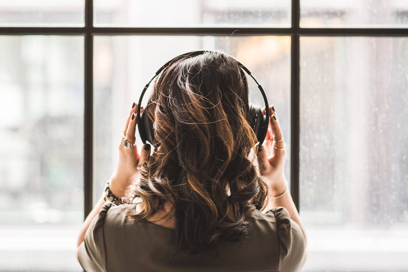 Woman listening to music wearing headphones