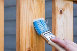 painting a porch witha paint brush