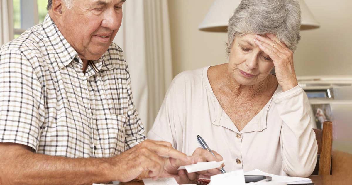 A senior couple working over their finances