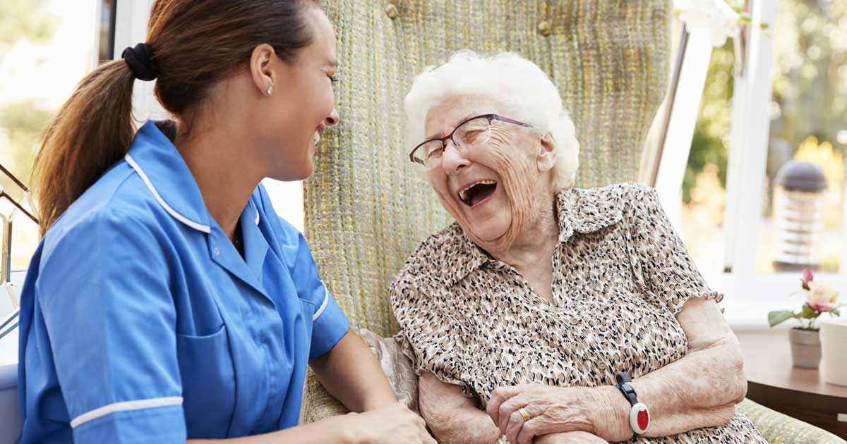 senior laughing with her caregiver