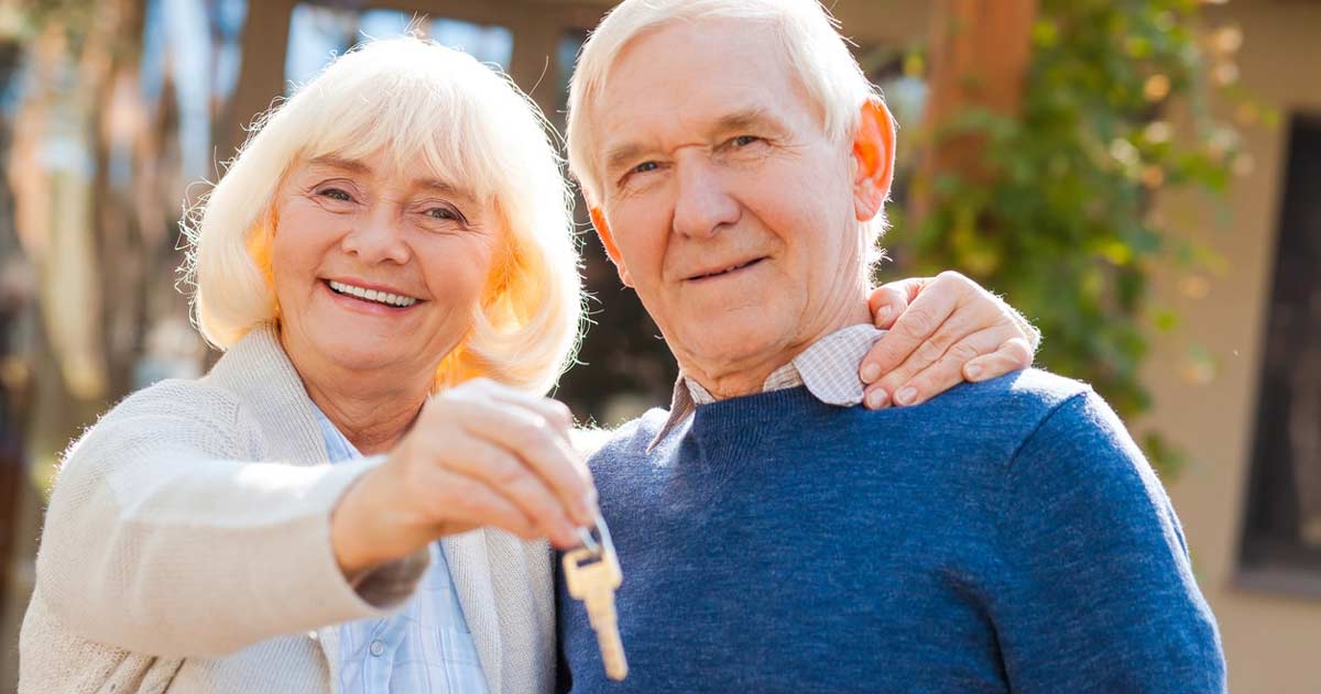 Senior couple with a house key