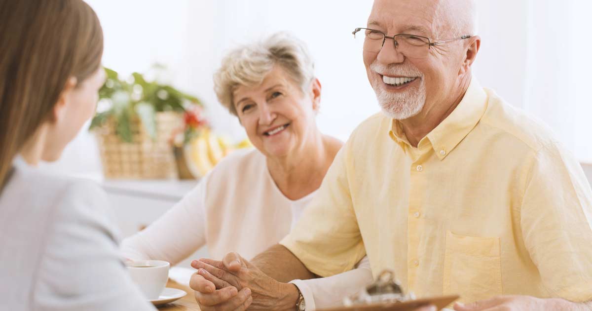 Senior couple talking with a financial planner