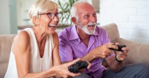 Senior couple playing video games on the couch
