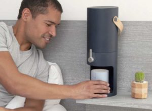 Man using portable water station placed on bedside table