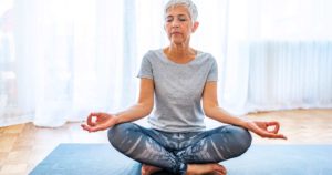 senior woman sitting in meditation