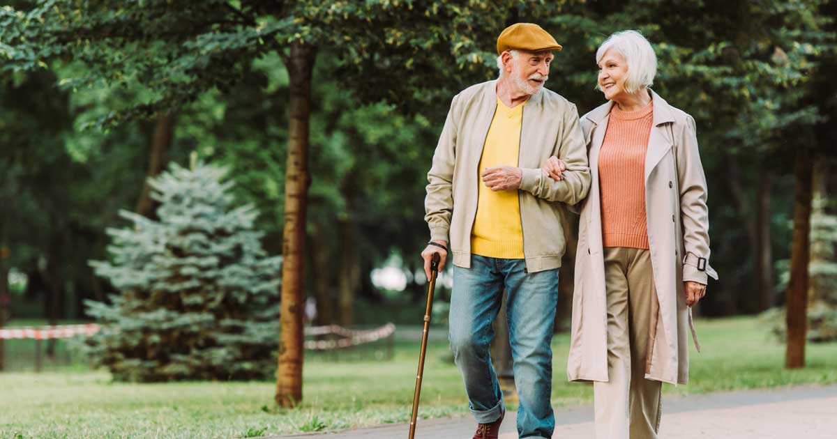 A senior couple walking in the park