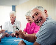 Seniors playing cards in assisted living residence