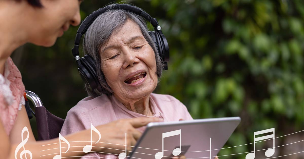 Elderly woman with dementia listening to music through headphones